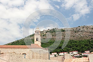 Ancient church top view, and stairs of Dubrovnik old town, hand made walls build with old bricks and stones, clock tower, bell tow