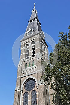 Ancient church tower against blue sky, Riel, Netherlands