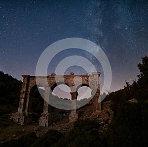 The ancient city of Ariassos, the city gate in a night when the Milky Way is visible