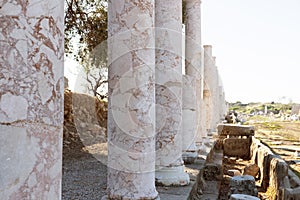 Ancient city of Side, Turkey. Perspective view of antique old marble colonnade. Close-up. Selective focus