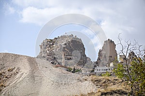 Ancient city Uchisar with rock castle, minaret of mosque and houses carved in the rock. Cappadocia, Turkey