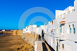 Ancient city wall of white medina of the town Asilah at ocean coast, Morocco