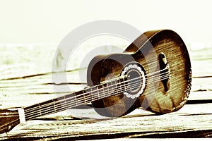 The ancient classical guitar on wooden boards