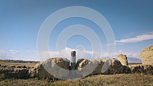 Ancient clay columns in the dry steppe. Remains of an ancient dwelling house. Autumn landscape. Tunkinskaya valley