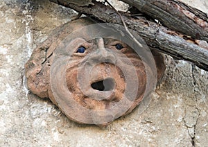 Ancient Clay face sculpture on the wall of a walkway in the Masseria Torre Coccaro