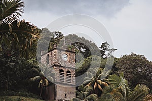 Ancient clock tower in the town in the middle of the forest