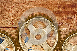 Ancient cog wheels against a rusty background
