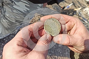 Ancient coins of the Russian Empire found during archaeological excavations, using a metal detector, the front and back background