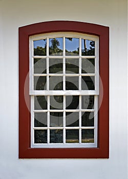 Ancient colonial window on white facade