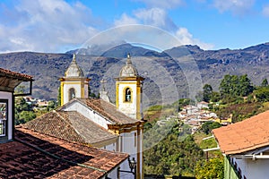 Ancient colorful baroque church with mountains