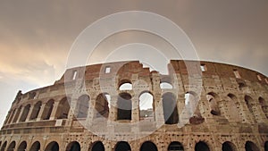 Ancient Colosseum against cloudy sky in center of Rome