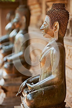 Ancient copper Buddha statues located outside of the Hor Phra Keo temple in Vientiane, Laos.