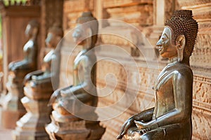 Ancient copper Buddha statues outside of the Hor Phra Keo temple in Vientiane, Laos.