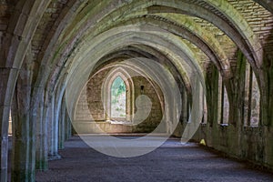 Ancient corridor in monastery with arches