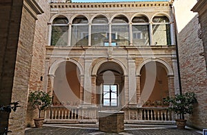 Ancient courtyard with arches well and window with panorama