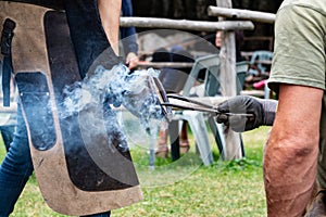 Ancient craft job man burning horse shoeing