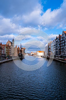 Ancient crane - zuraw Old town in Gdansk. The riverside on Granary Island reflection in Moltawa River. Visit Gdansk