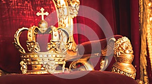 Ancient crown on red velvet. Antique symbol of authority, luxury, monarchy, nobility