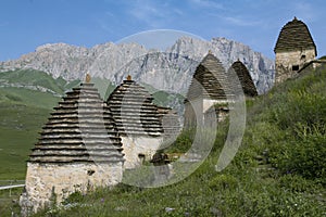 The ancient crypts of the city of the dead Dargavs against the background of the mountains photo