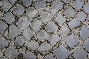 Ancient dark granite stone floor pattern as background in Rome,