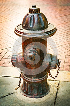 Ancient Dark red Fire Department Connection in public space