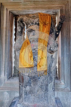 An ancient decapitated stone sculpture of Buddha in a Cambodian temple