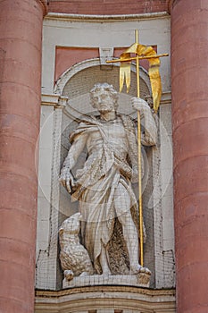 Ancient decorative wall sculpture at the main facade of New Munster Catholic Church in historical downtown of Wurzburg, Germany