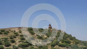 The ancient defensive fortress wall is visible on the ridge of the mountain.