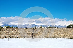 Ancient defensive walls of the fortress with beautiful mountains background