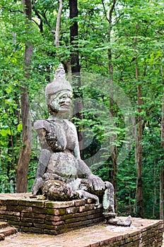 Ancient demon statue in Wat Umong ,Thailand.