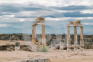 The ancient destroyed city of Hierapolis near Pamukkale, Denizli, Turkey in the summer. On a background the sky in overcast. Horiz