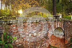 Ancient disintegrated red brick bridge in the forest old in the evening, Mtsyri, Serednikiovo, Moscow region, Russia.