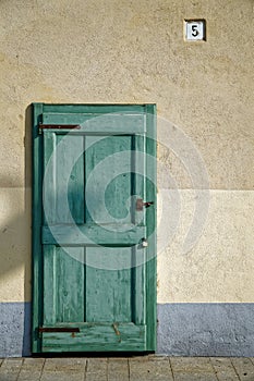 Ancient door in green color, cracked wooden entrance, sample for post card