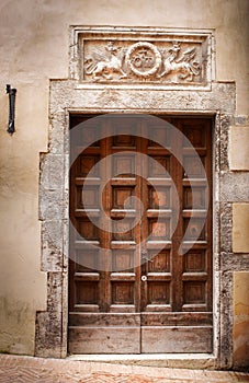 Ancient wooden door of a historic building in Perugia (Tuscany, Italy) photo