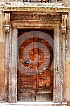 Ancient wood door of a historic building in Perugia (Tuscany, Italy) photo