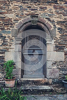 Ancient door. Old vintage rustic wooden door in French village