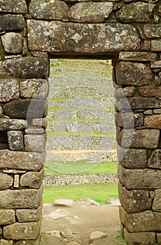 Ancient doorway with the remains of the Inca Ruins in Machu Picchu Citadel, Cusco Region, Peru