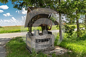 Ancient draw-well in European village. Beautiful Well with Bucket in Rural Area. Decorated. Country side in Lithuania