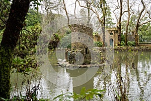 Ancient duck houses resembling a tower or castle at Pena Palace gardens in the Valley of Lakes area of Sintra Portugal