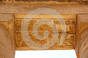 Ancient Egyptian hieroglyphs carved on the stone. The roof of the temple at Karnak