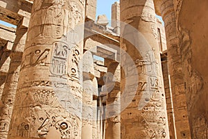 Ancient Egyptian hieroglyphs and symbols carved on columns of the complex of the Karnak temple