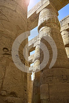 Ancient Egyptian hieroglyphs and symbols carved on columns of the complex of Karnak temple. Great Hypostyle Hall at Temples of