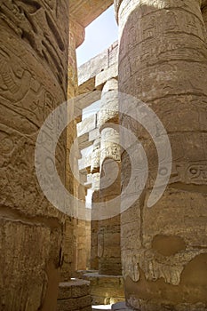 Ancient Egyptian hieroglyphs and symbols carved on columns of the complex of Karnak temple. Great Hypostyle Hall