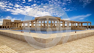 Ancient Egyptian pharaohs palace with stone columns and a large blue water pool. 3D rendering