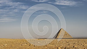The ancient Egyptian pyramid of Mykerin on the background of the blue sky.