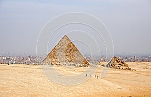 Ancient Egyptian pyramids of Giza against sandy sky