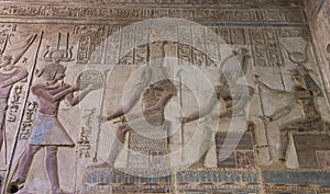 Ancient egyptian temple wall with hieroglyphic carving paintings