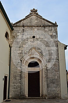 Ancient Elegance: Weathered Stone Doorway Building in Historic Croatia