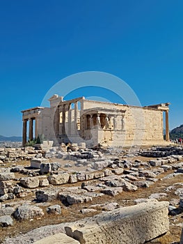 Ancient Erechtheion temple with Caryatid Porch on Acropolis, Athens, Greece. Famous Acropolis hill is top landmark of Athens.