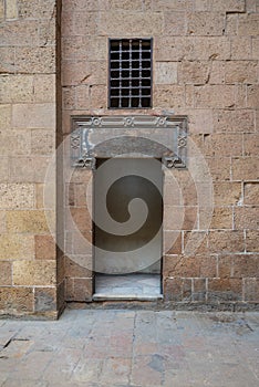 Ancient external old decorated bricks stone wall and opened door, Cairo, Egypt photo